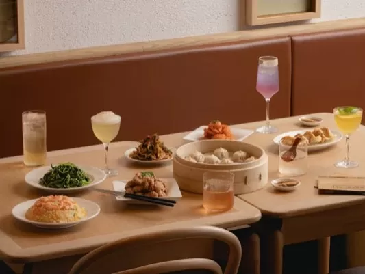 Dishes, dumplings and cocktails on a table at Din Tai Fung
