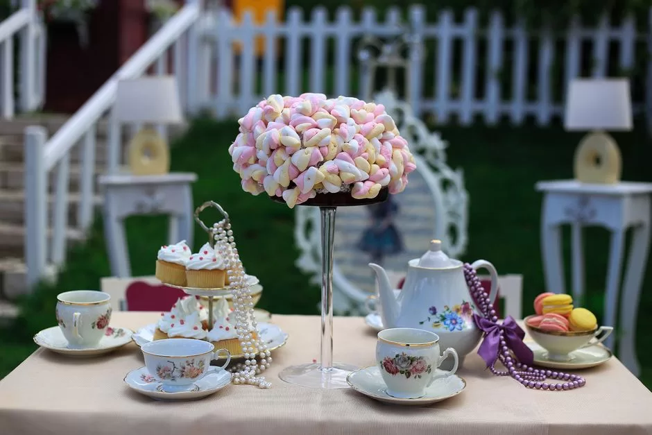 An afternoon tea cake stand, teapot and china cups