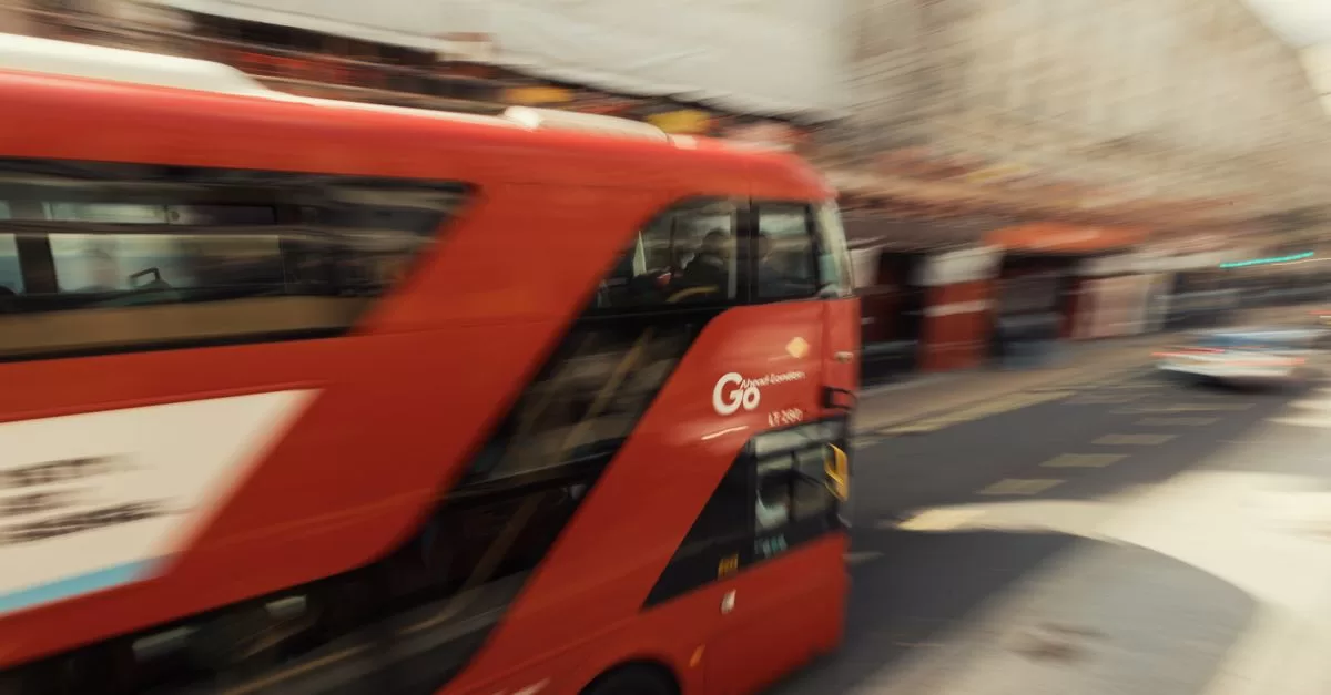 A red London bus on a city street