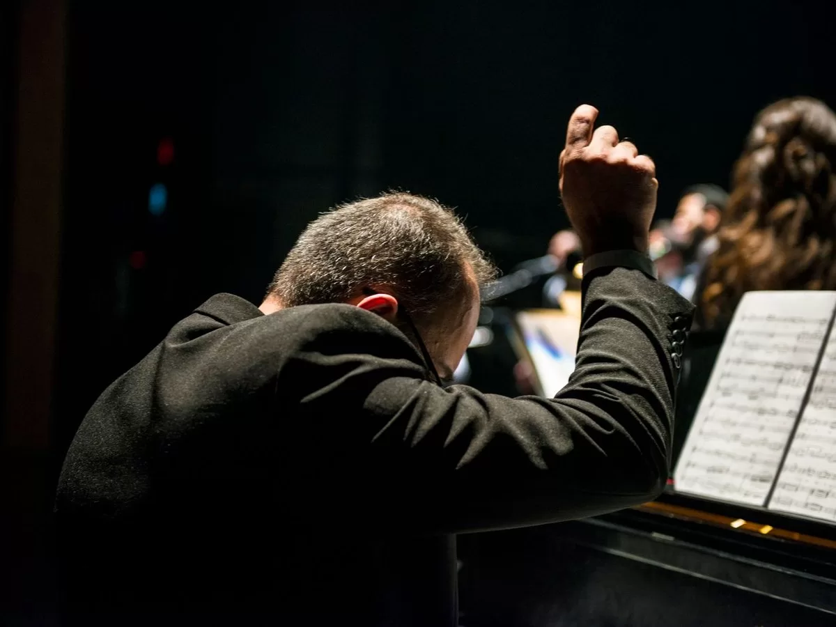 An orchestra performing in a concert hall