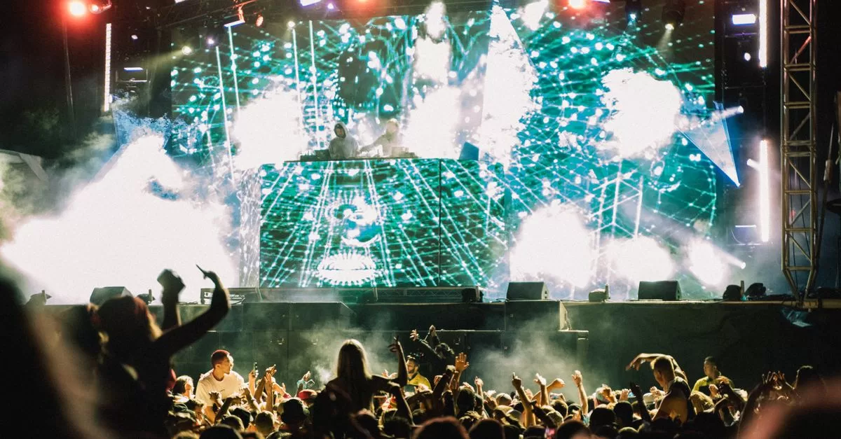 A crowd in front of an outdoor festival stage