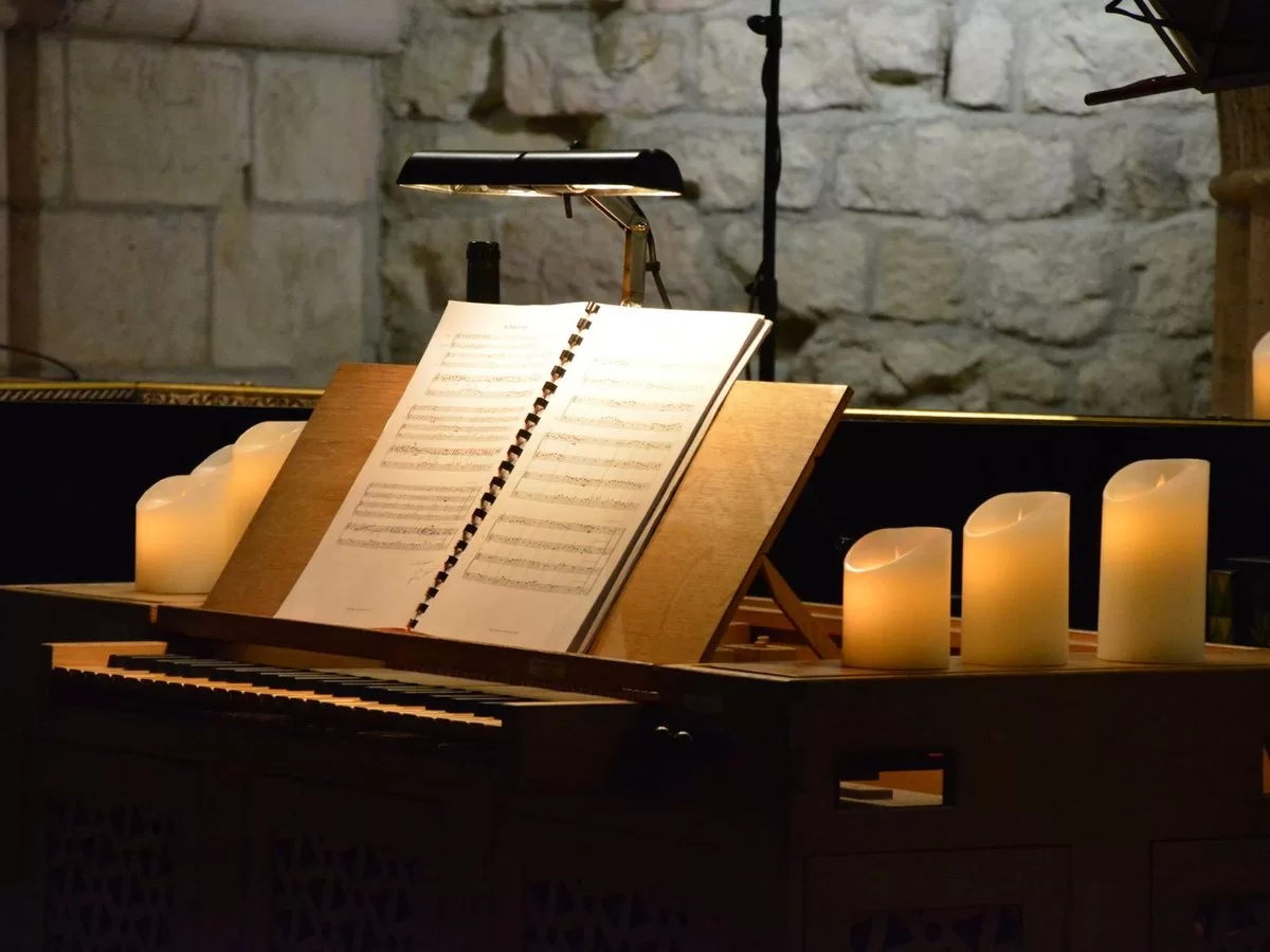 A candlelit interior set for a concert