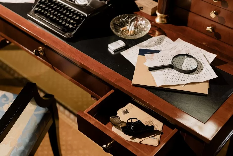 A desk of puzzles, a typewriter and a magnifying glass