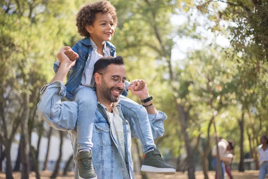 A father and child walking in a park