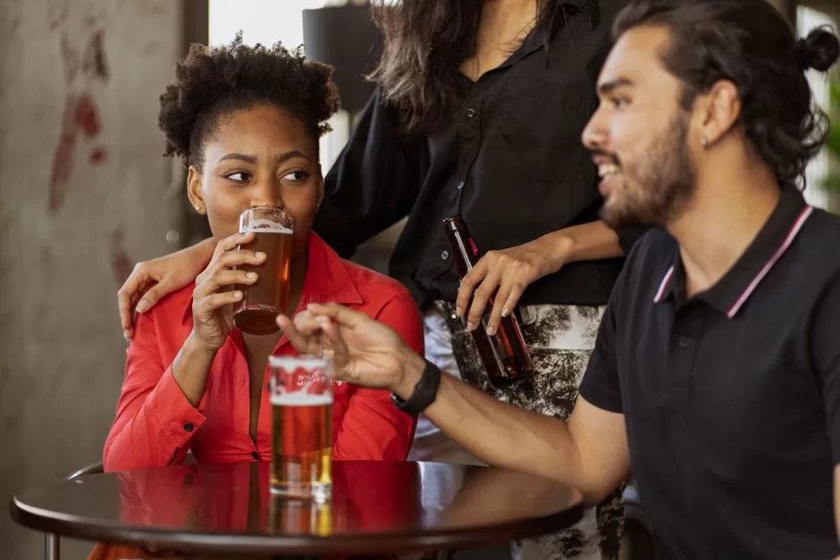 Friends with drinks around a pub table