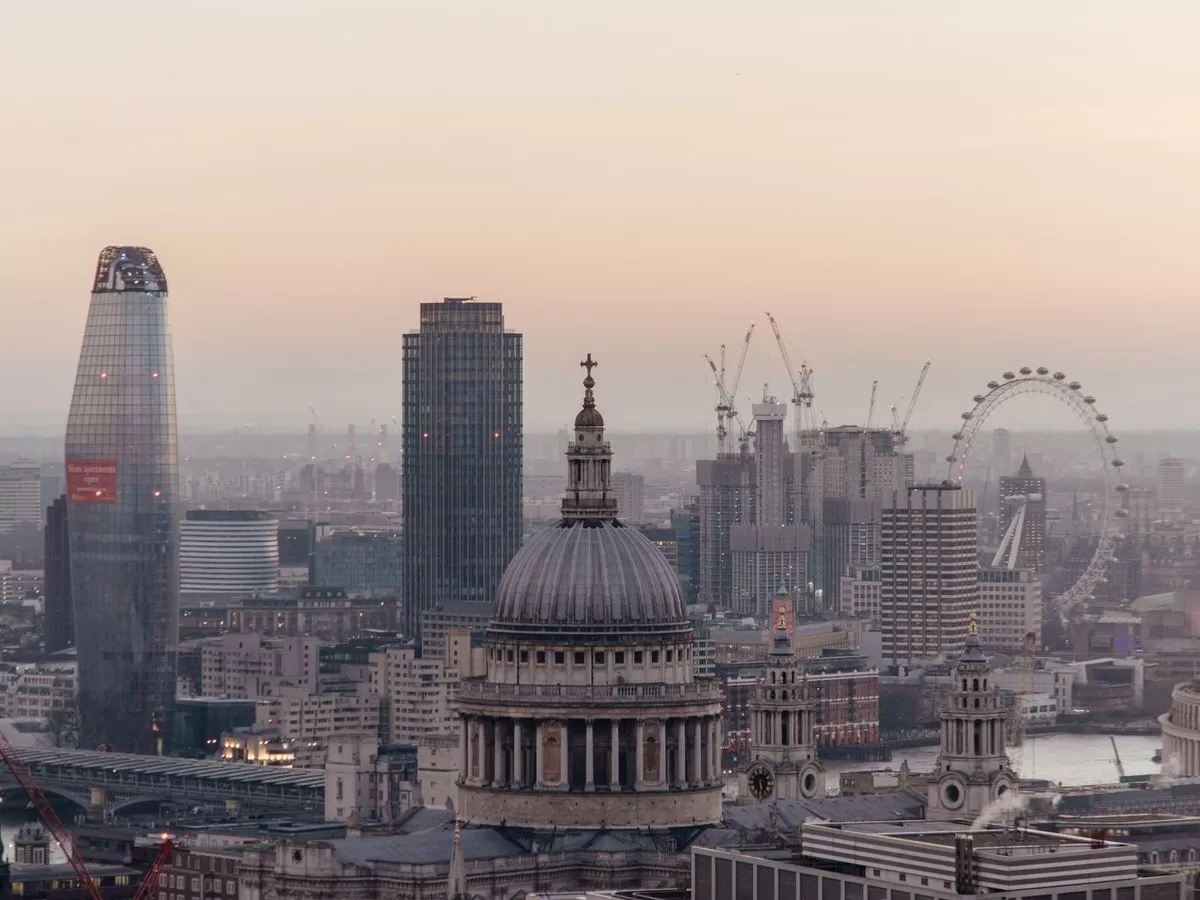 A rooftop bar overlooking the city at sunset