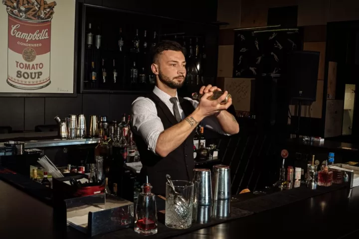 A man mixing alcoholic drinks