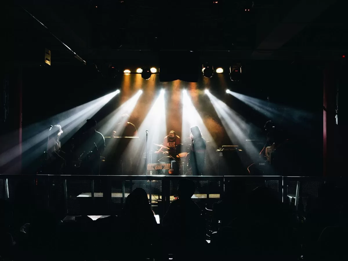 A band on stage under coloured lights