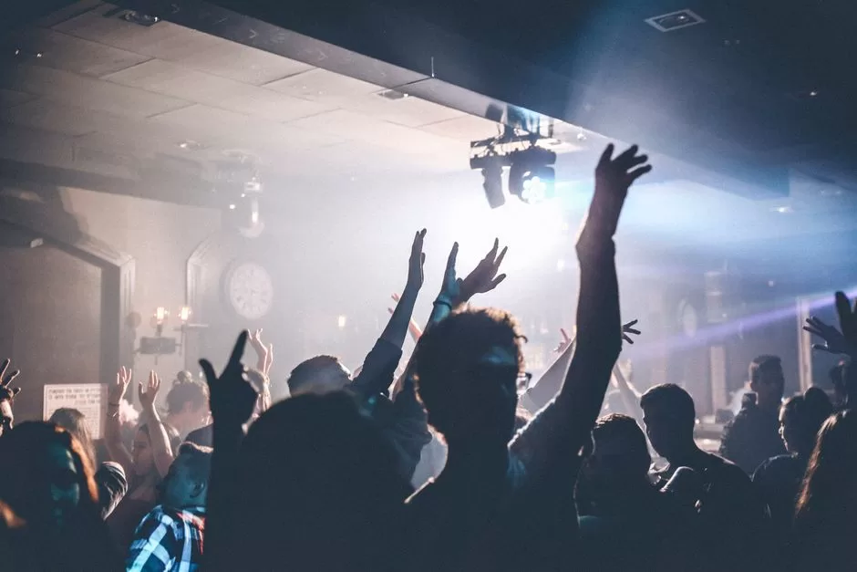 A nightclub crowd with hands in the air