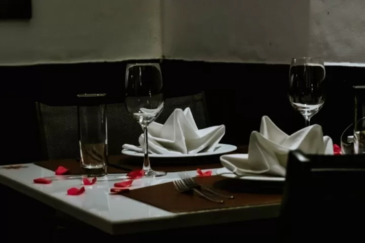 A table set for two with two glasses of wine