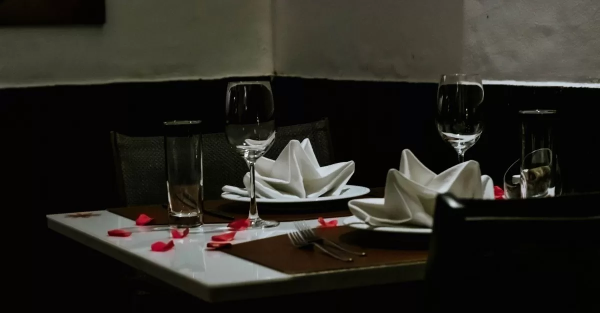 A table set for two with two glasses of wine