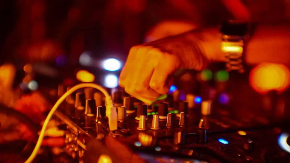 A DJ playing to a busy bar
